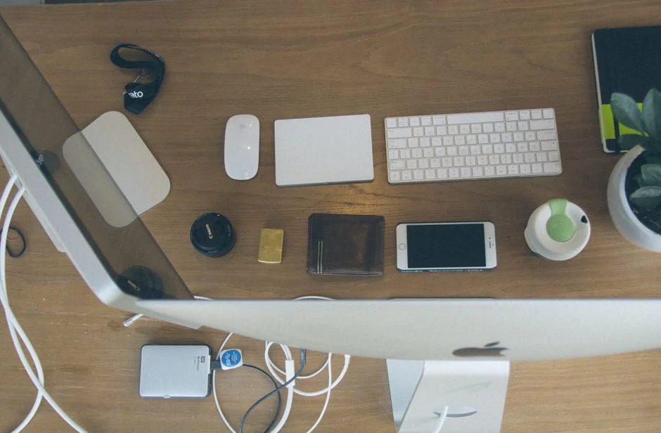 A bright desk setup featuring a design book, laptop, and creative tools, ideal for inspiration.